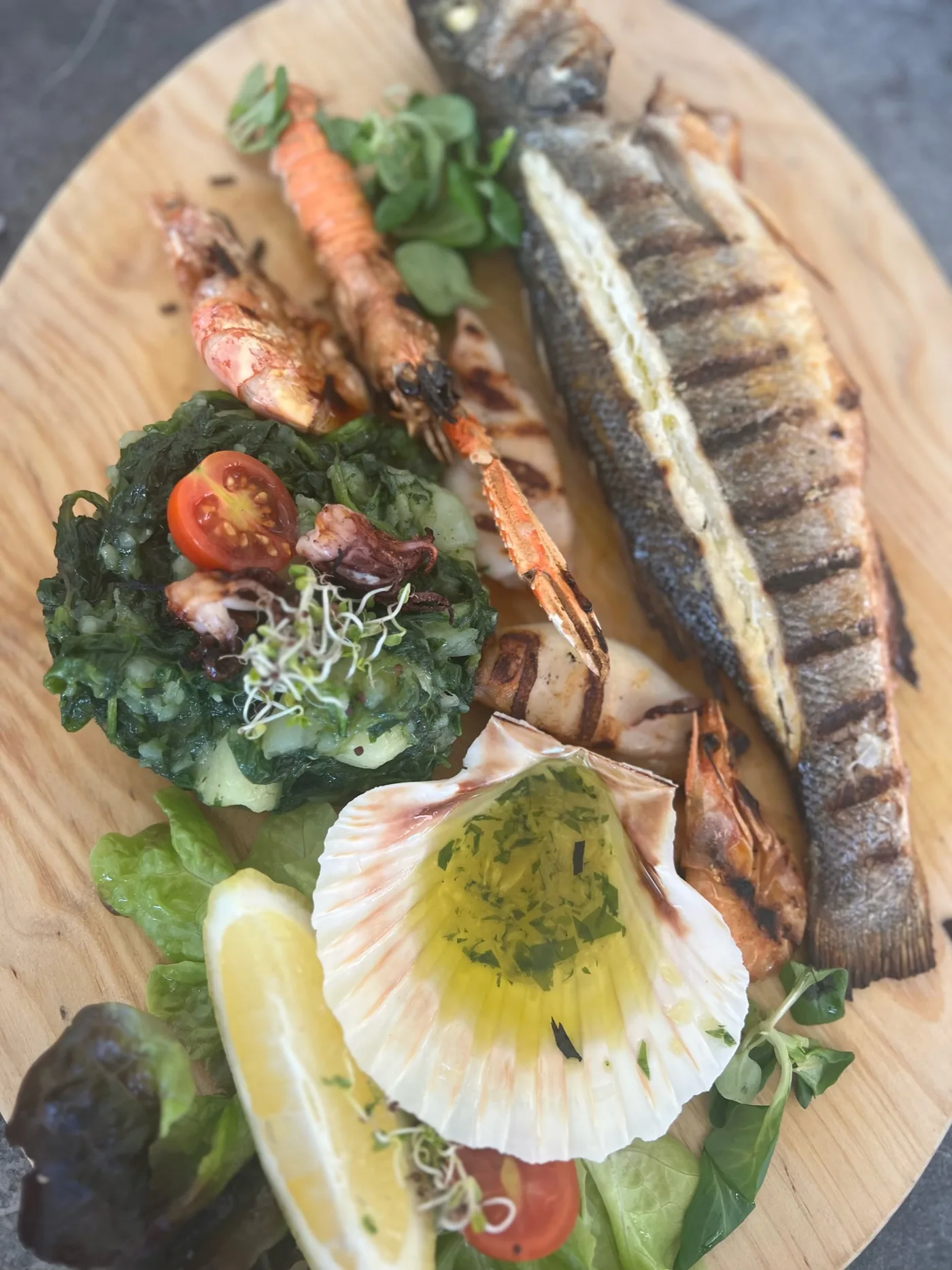 A chilled seafood platter on ice, shot from above on a laid table.